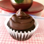 a moist chocolate cupcake frosted with chocolate icing